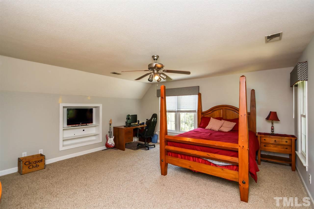 5912 Hampton Ridge Road Raleigh, NC 27603 - Photo 14 of 22 a bedroom with furniture and a window