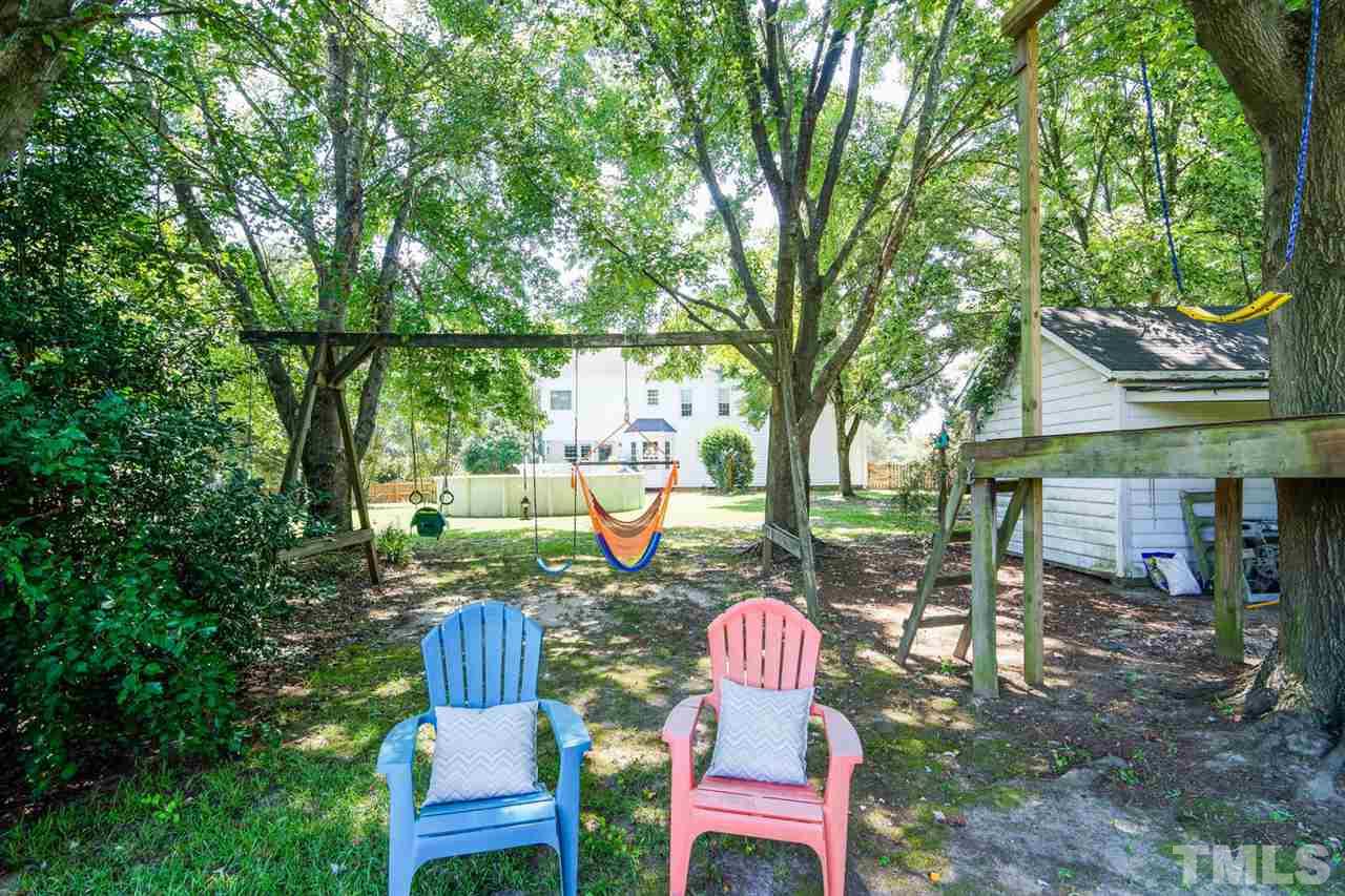 5912 Hampton Ridge Road Raleigh, NC 27603 - Photo 17 of 22 a backyard of a house with table and chairs