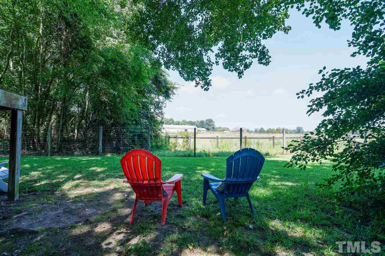 5912 Hampton Ridge Road Raleigh, NC 27603 - Photo 19 of 22 a view of a table and chairs in the garden