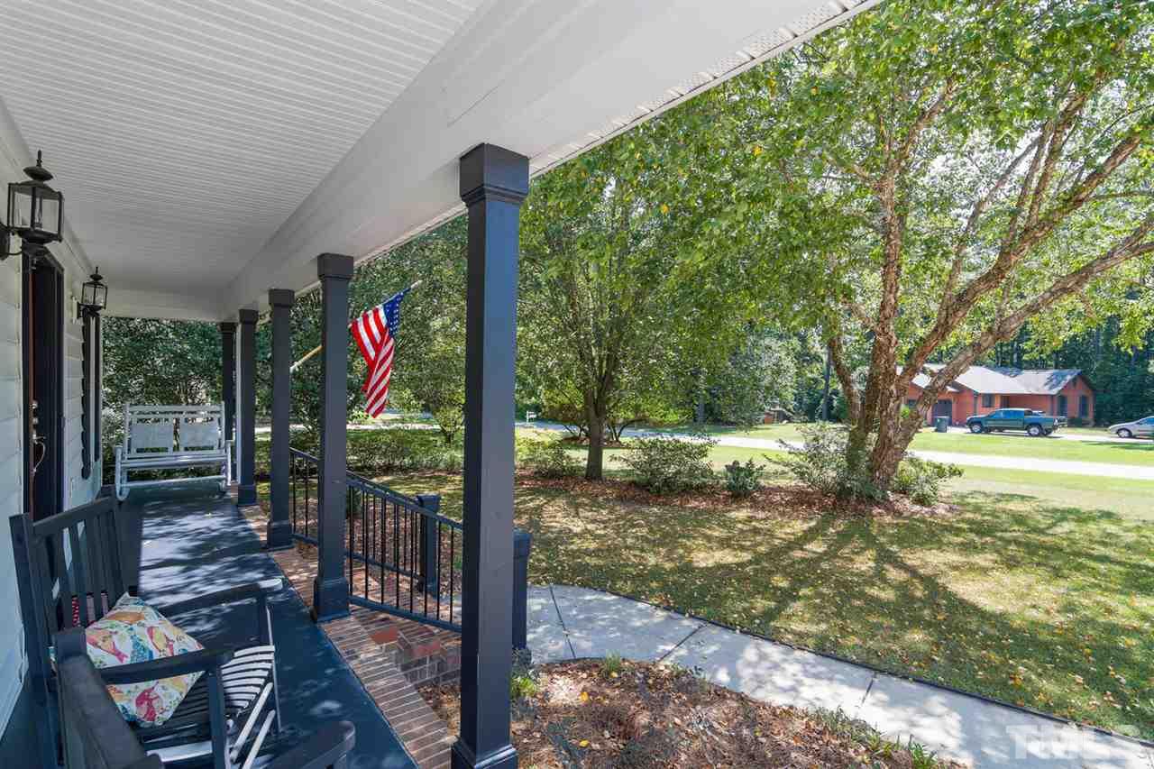 5912 Hampton Ridge Road Raleigh, NC 27603 - Photo 3 of 22 a view of a porch with furniture and garden