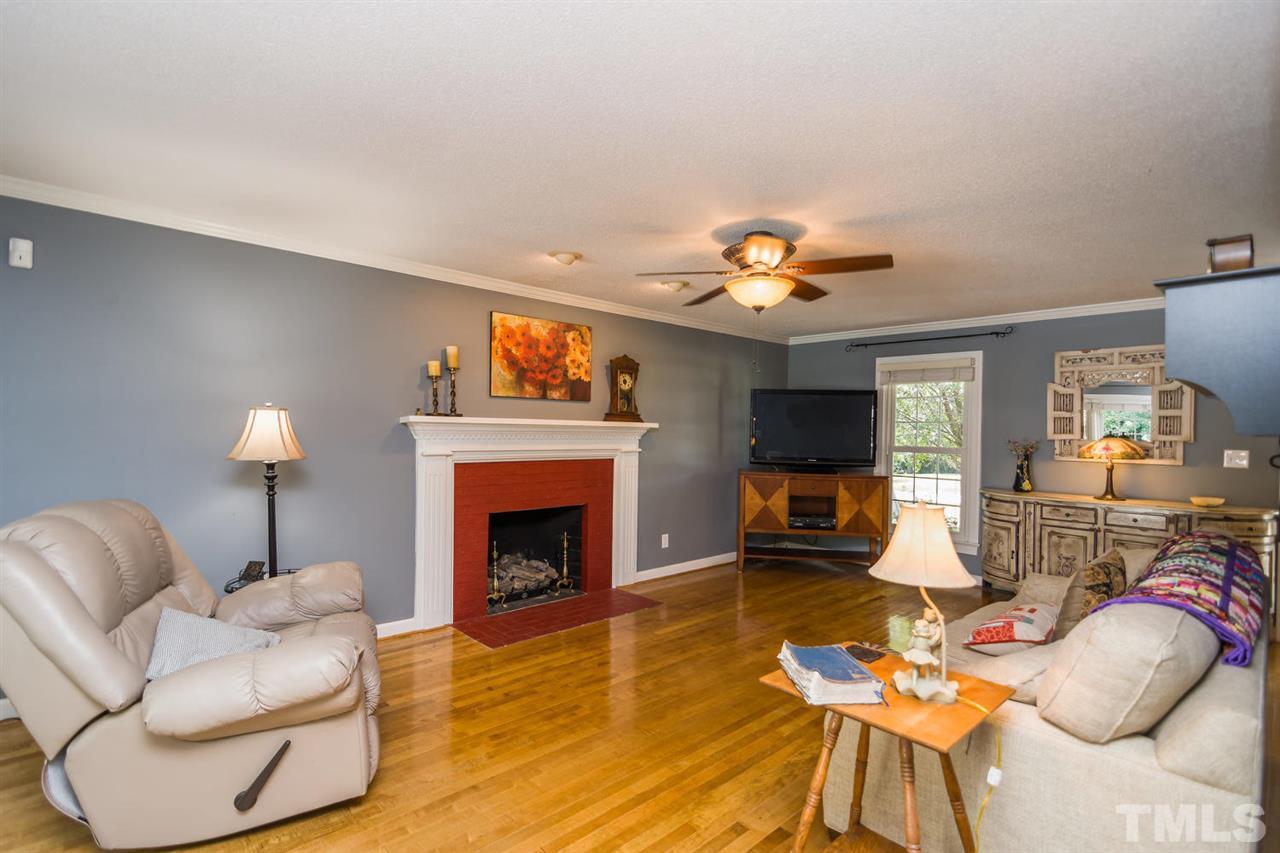 5912 Hampton Ridge Road Raleigh, NC 27603 - Photo 4 of 22 a living room with furniture and a fireplace