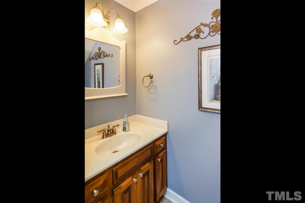 5912 Hampton Ridge Road Raleigh, NC 27603 - Photo 8 of 22 a bathroom with a sink and a mirror