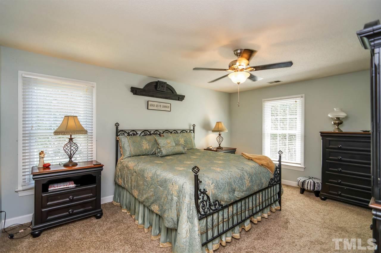 5912 Hampton Ridge Road Raleigh, NC 27603 - Photo 9 of 22 a bedroom with a bed and a chandelier
