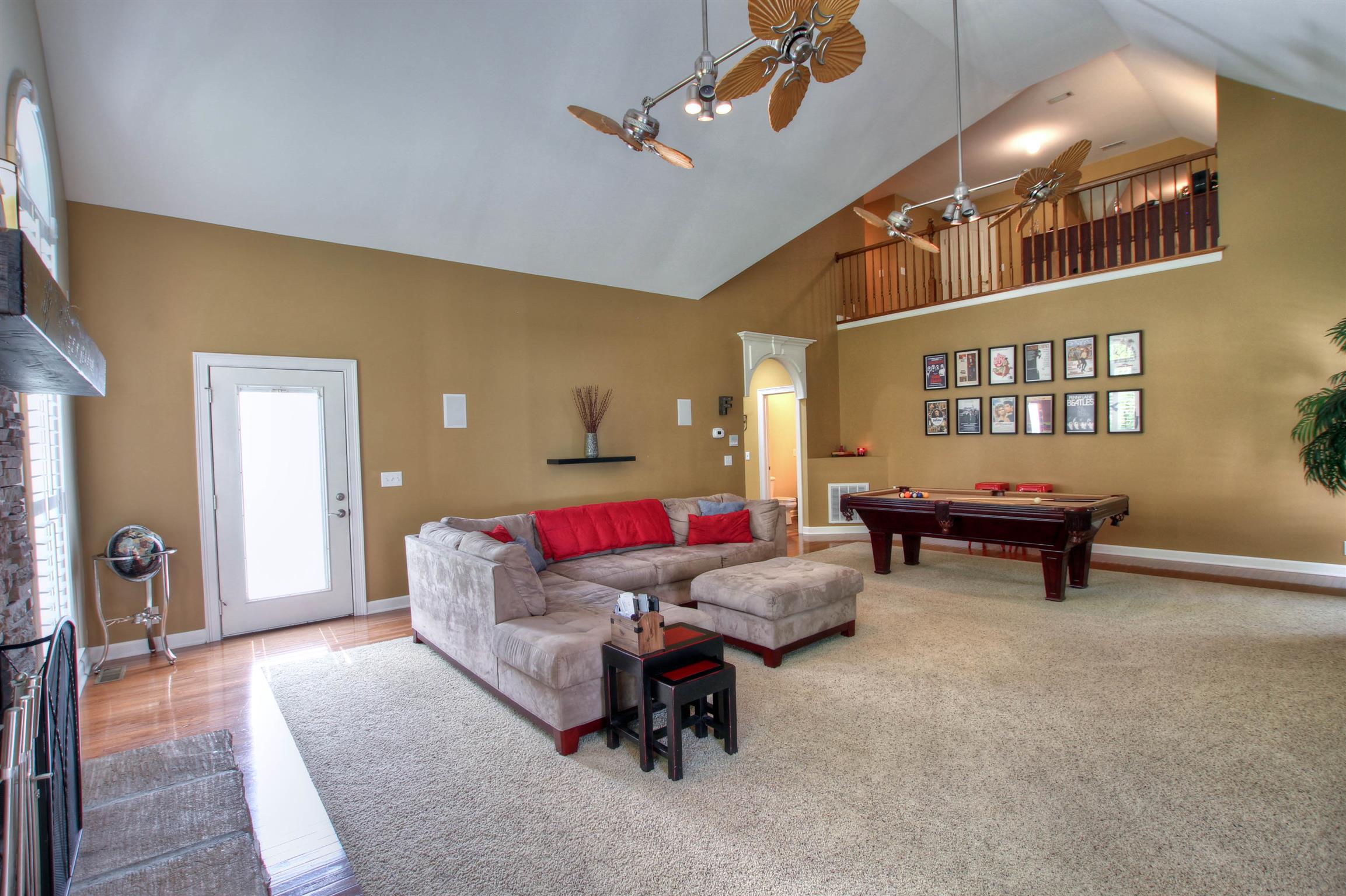 9185 Arnold Road Christiana, TN 37037 - Photo 17 of 30 Vaulted ceilings, stone fireplace. Door leads out to backyard.