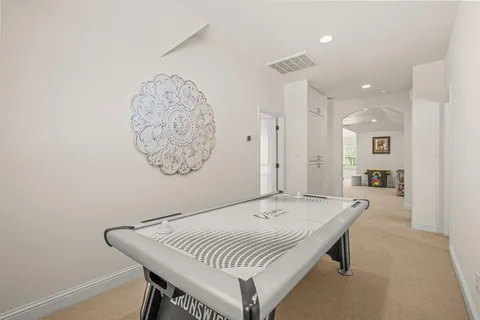 a living room with a table and chairs