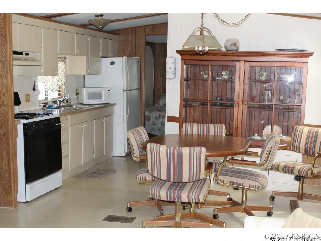127 Charles Street Edgewater, FL 32141 - Photo 6 of 10 a kitchen with stainless steel appliances kitchen island granite countertop a refrigerator and a stove top oven