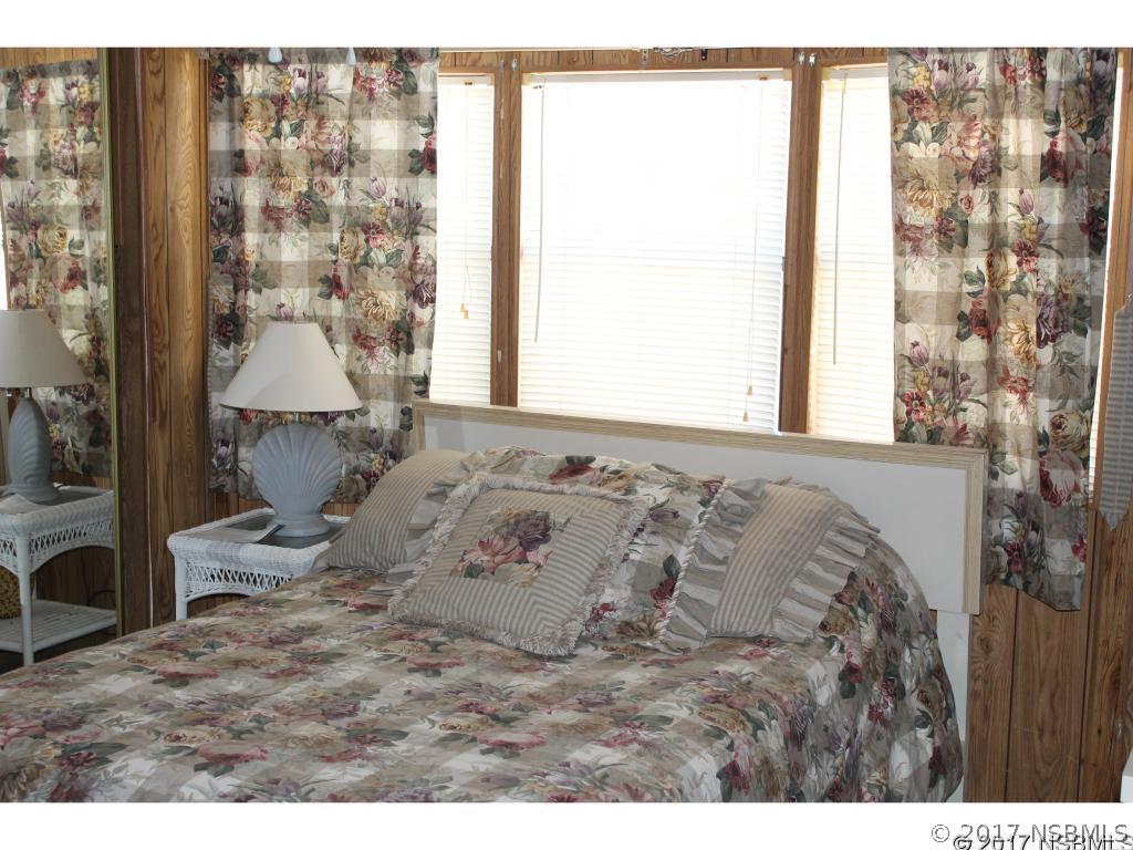127 Charles Street Edgewater, FL 32141 - Photo 10 of 10 a bedroom with a bed and a window