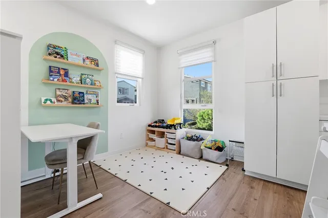 a bedroom with furniture and a wooden floor