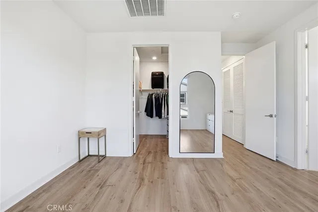 a big room with wooden floor and a sink