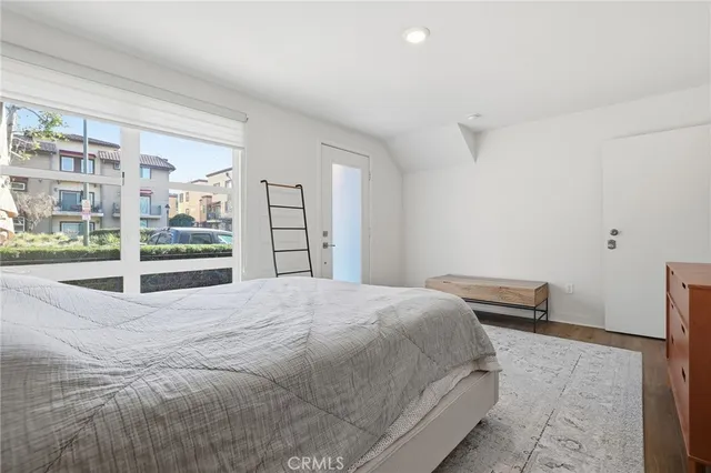 a bedroom with a bed and a large window