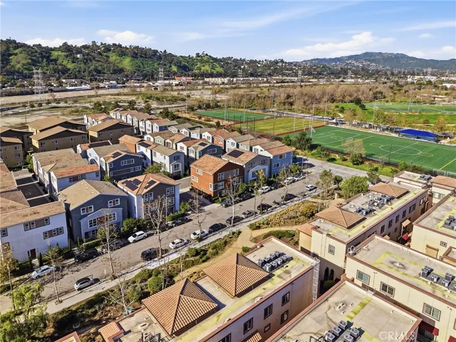 an aerial view of a residential houses with yard
