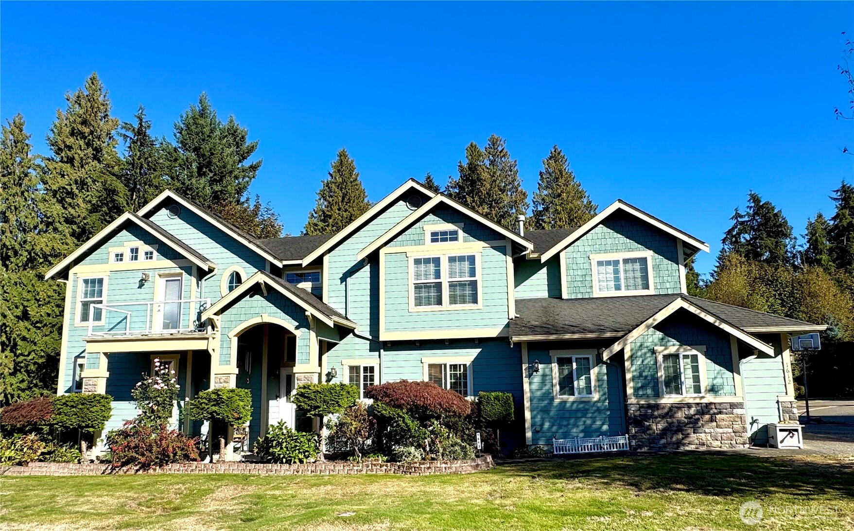 a front view of a house with yard and porch