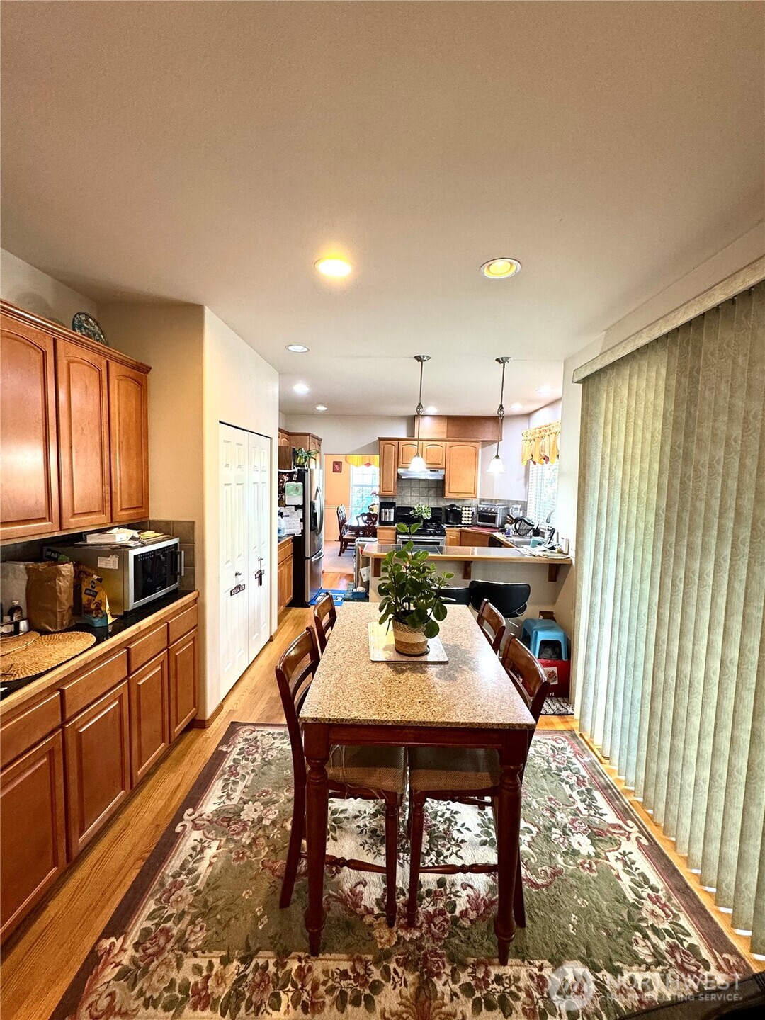 1612 Holbrook Avenue Everett, WA 98203 - Photo 6 of 23 a kitchen with stainless steel appliances wooden floor dining table and chairs