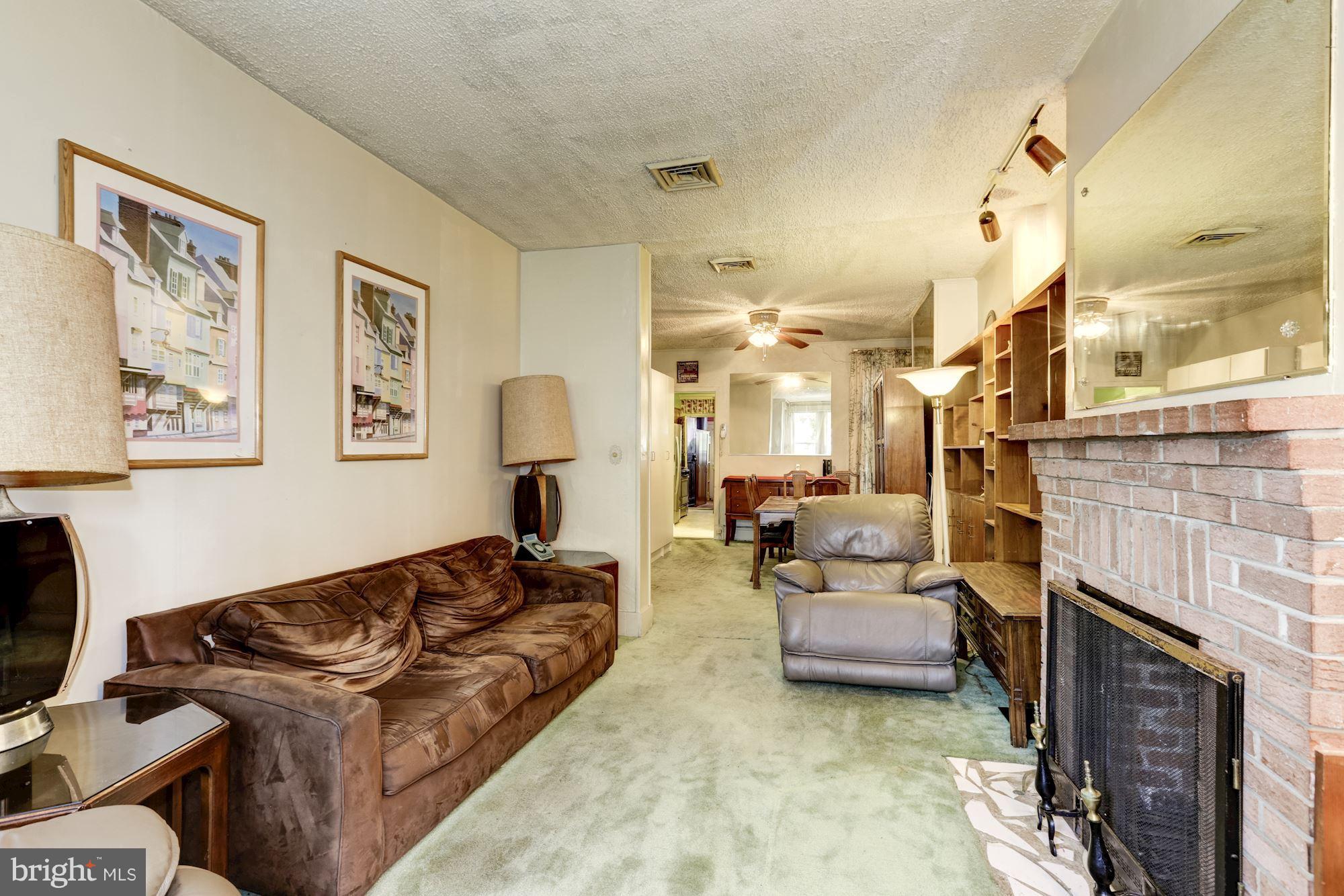 1216 D Street Northeast Washington, DC 20002 - Photo 2 of 18 a living room with furniture and a fireplace