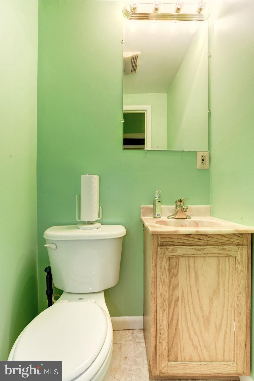 1216 D Street Northeast Washington, DC 20002 - Photo 5 of 18 a bathroom with a toilet sink and mirror