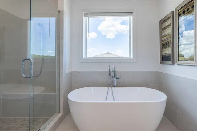 a white bath tub sitting next to a shower