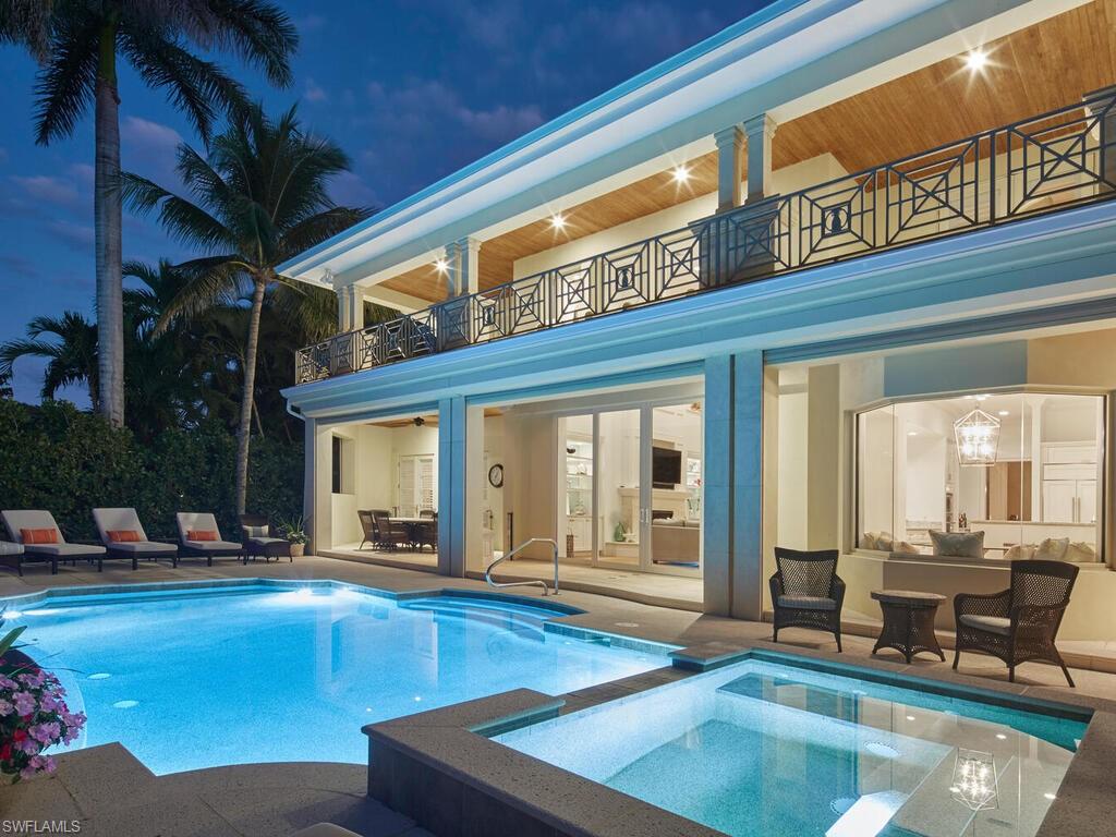 377 Pirates Bight Naples, FL 34103 - Photo 3 of 44 a view of a kitchen with a large pool table and chairs