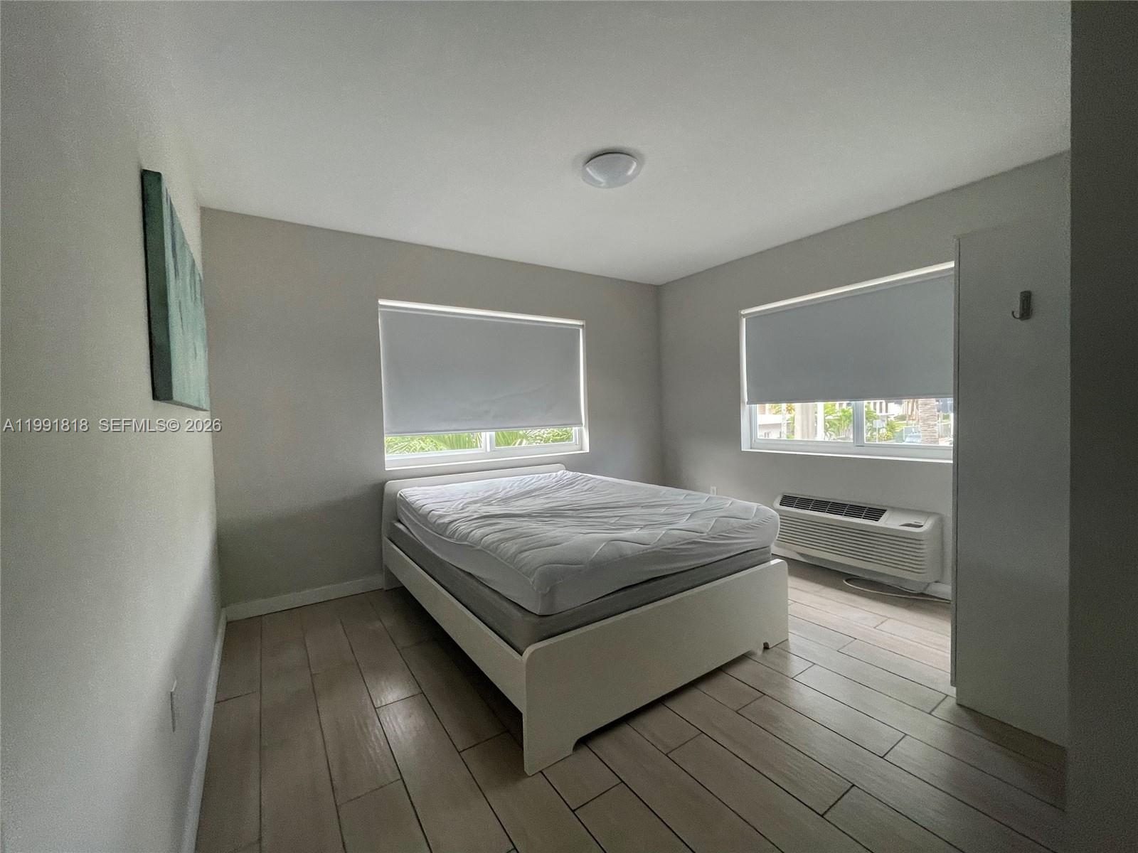 625 77th Street, Unit 2 Miami Beach, FL 33141 - Photo 11 of 17 a bedroom with a bed and window
