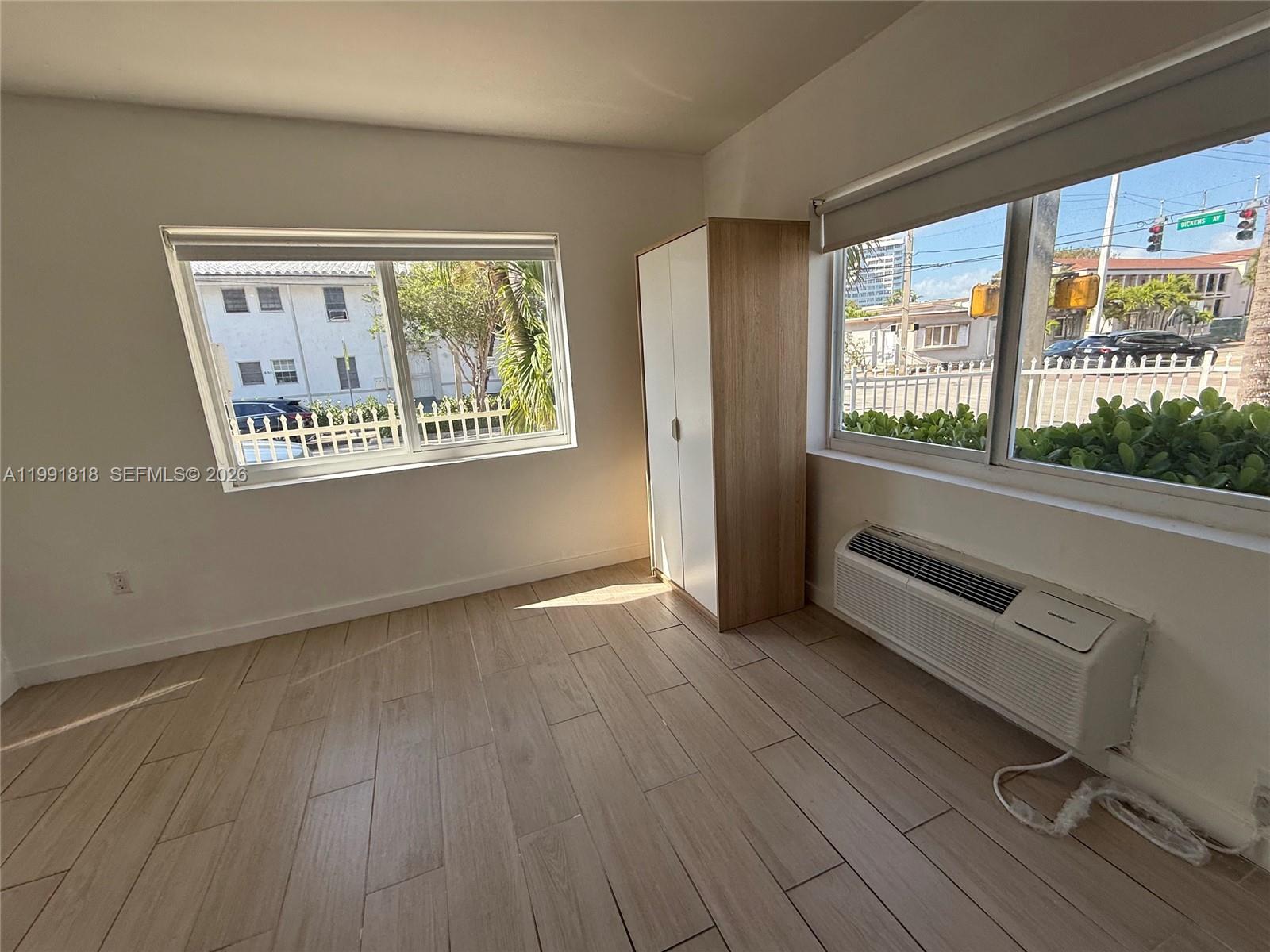 625 77th Street, Unit 2 Miami Beach, FL 33141 - Photo 12 of 17 an empty room with wooden floor and windows