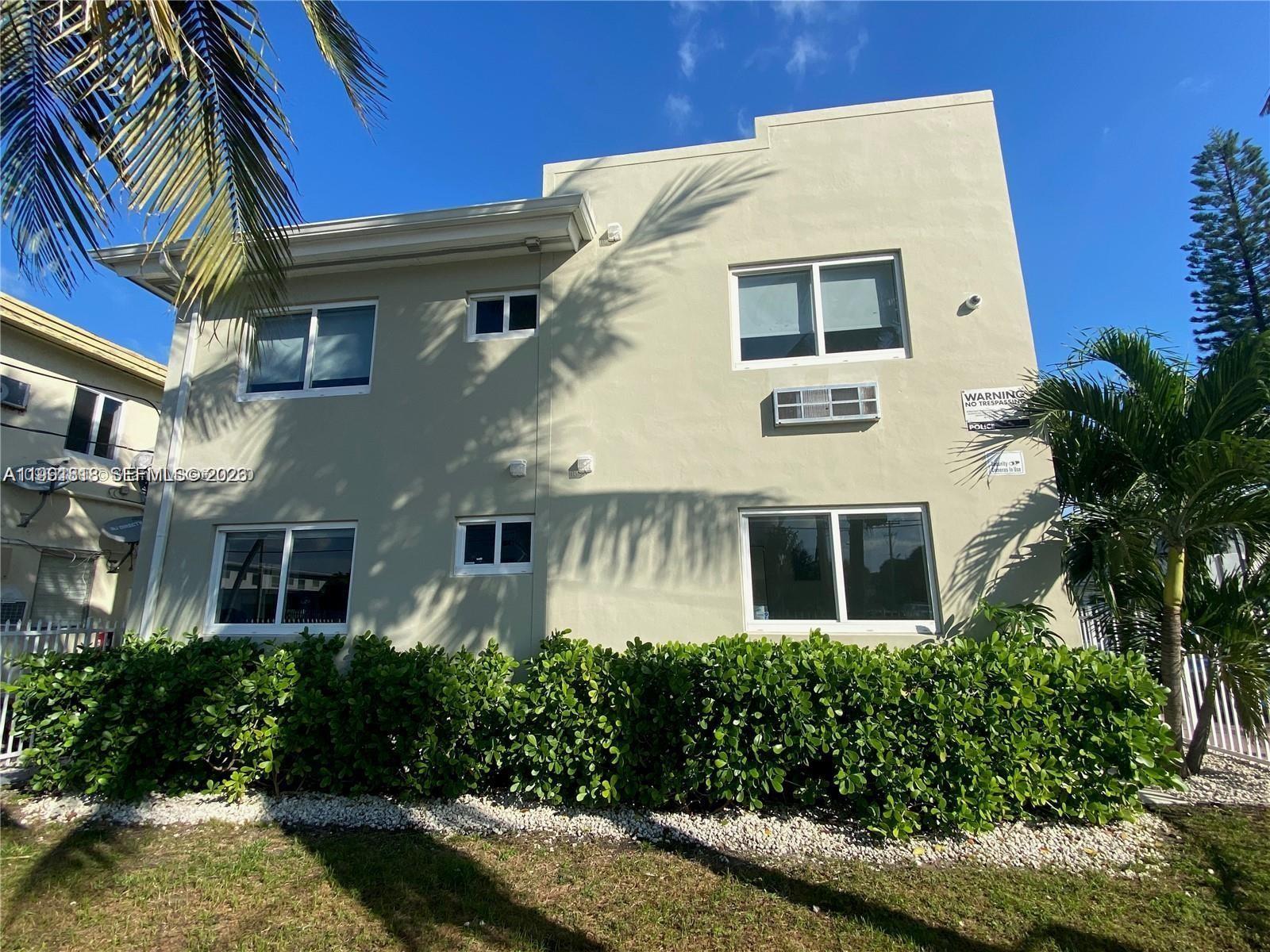 625 77th Street, Unit 2 Miami Beach, FL 33141 - Photo 17 of 17 a front view of a house with a yard