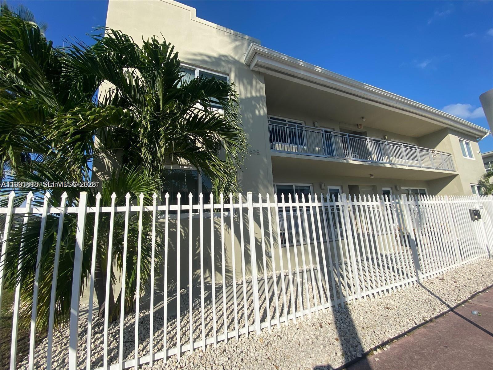 625 77th Street, Unit 2 Miami Beach, FL 33141 - Photo 2 of 17 a front view of a house with a garden