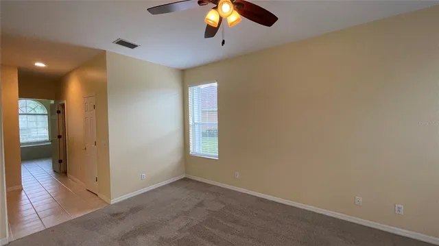 an empty room with closet and windows
