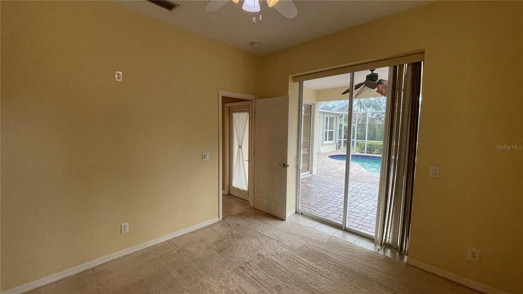 10812 Bullrush Terrace Lakewood Ranch, FL 34202 - Photo 27 of 44 an empty room with chandelier fan and windows