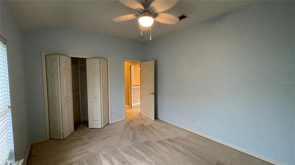 10812 Bullrush Terrace Lakewood Ranch, FL 34202 - Photo 31 of 44 an empty room with closet and a chandelier fan