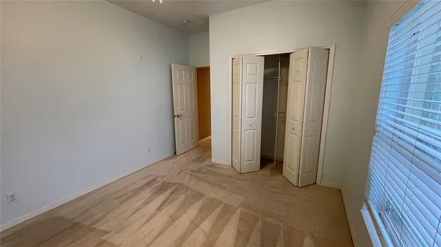 a view of a room with an empty space and wooden floor