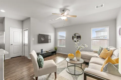 a living room with furniture a wooden floor and a window