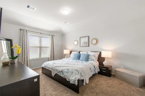 a bedroom with a bed and painting on the wall