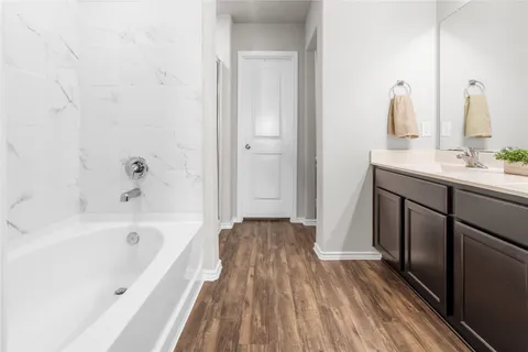 a bathroom with a bathtub and a sink