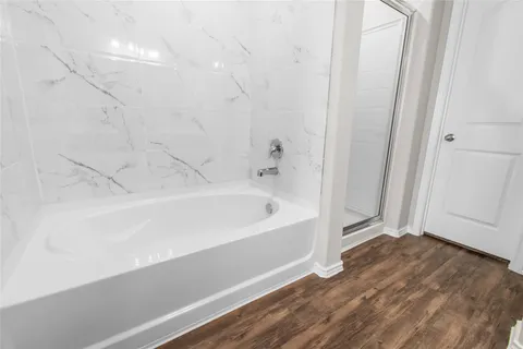 a bathroom with a bathtub and shower