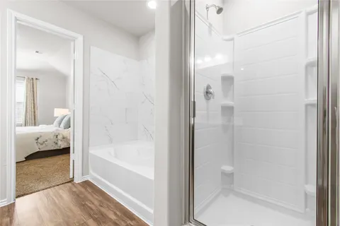 a bathroom with a tub and shower
