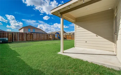 a view of a house with a yard porch and furniture