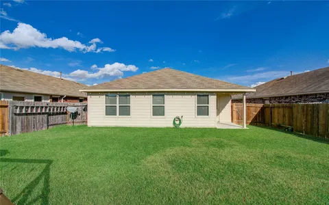 a view of a house with a backyard