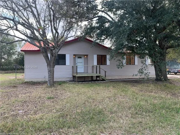 a house with trees in the background
