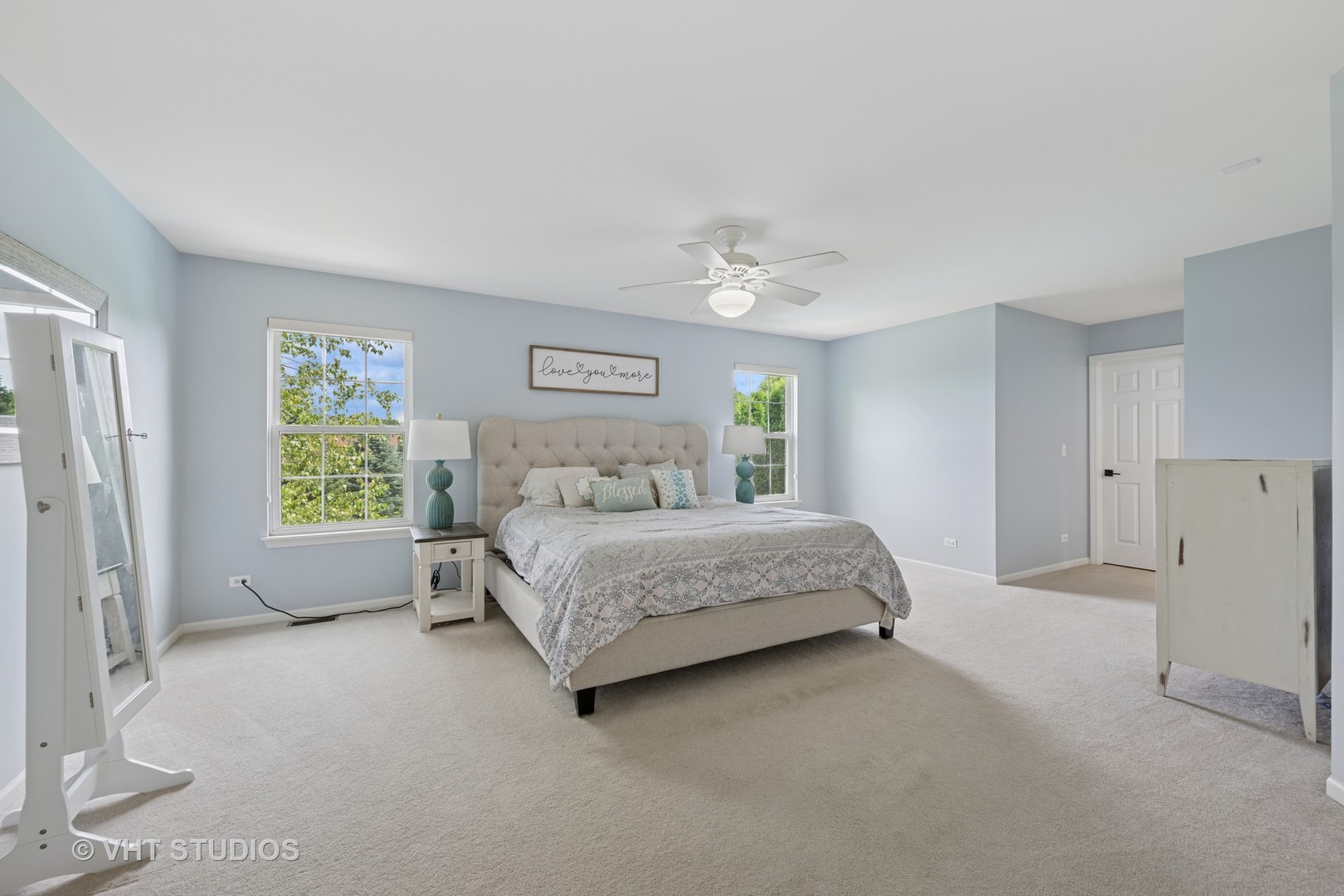 390 Sterling Circle Cary, IL 60013 - Photo 16 of 55 a bedroom with a bed chandelier and a window
