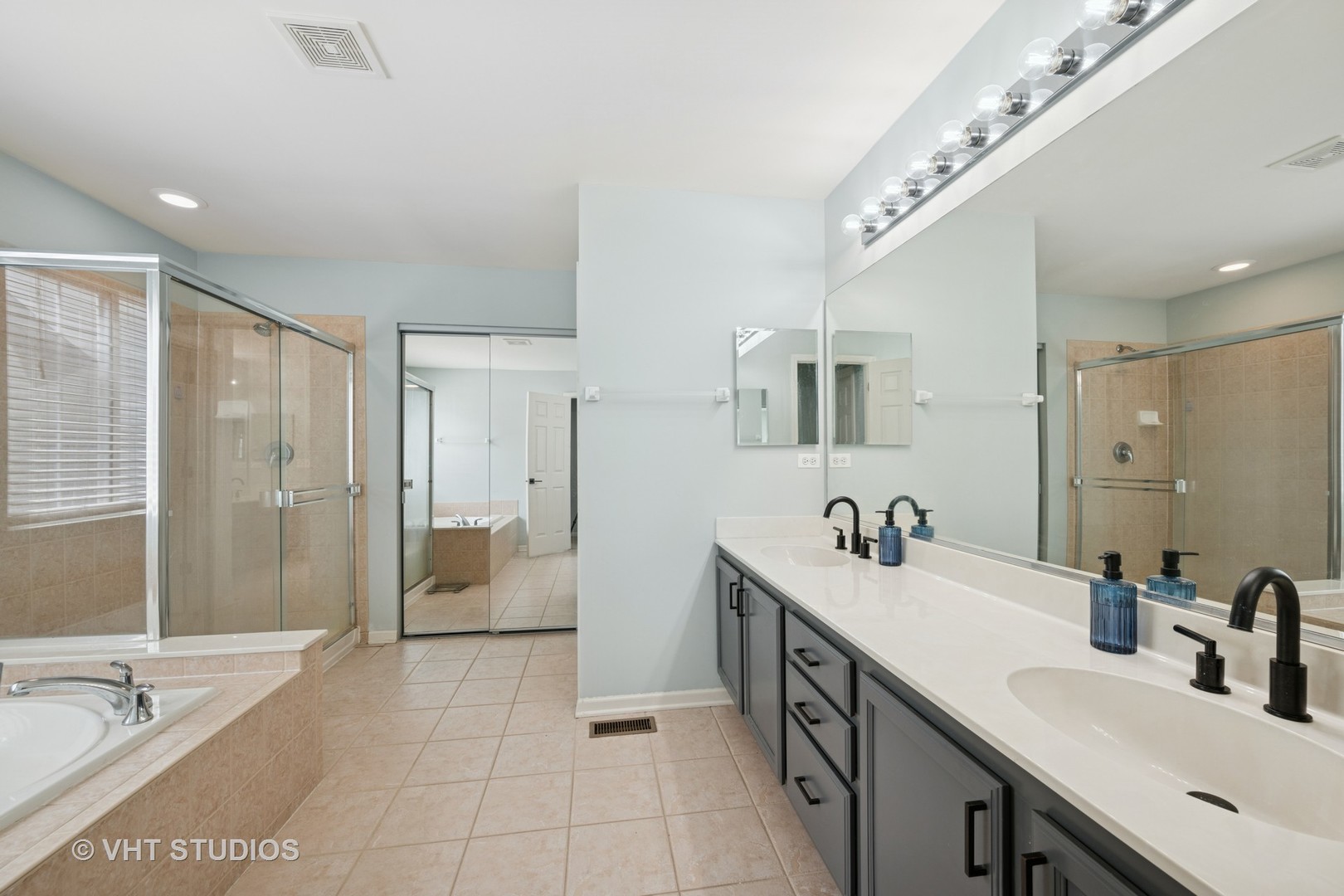 390 Sterling Circle Cary, IL 60013 - Photo 17 of 55 a spacious bathroom with a double vanity sink a large mirror and a shower