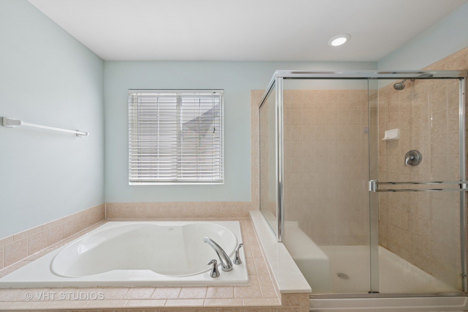 390 Sterling Circle Cary, IL 60013 - Photo 18 of 55 a bathroom with a tub and a shower