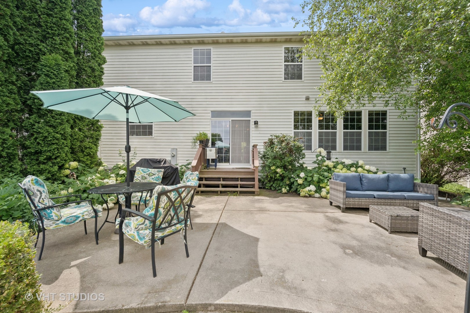390 Sterling Circle Cary, IL 60013 - Photo 33 of 55 a view of a house with backyard sitting area and garden