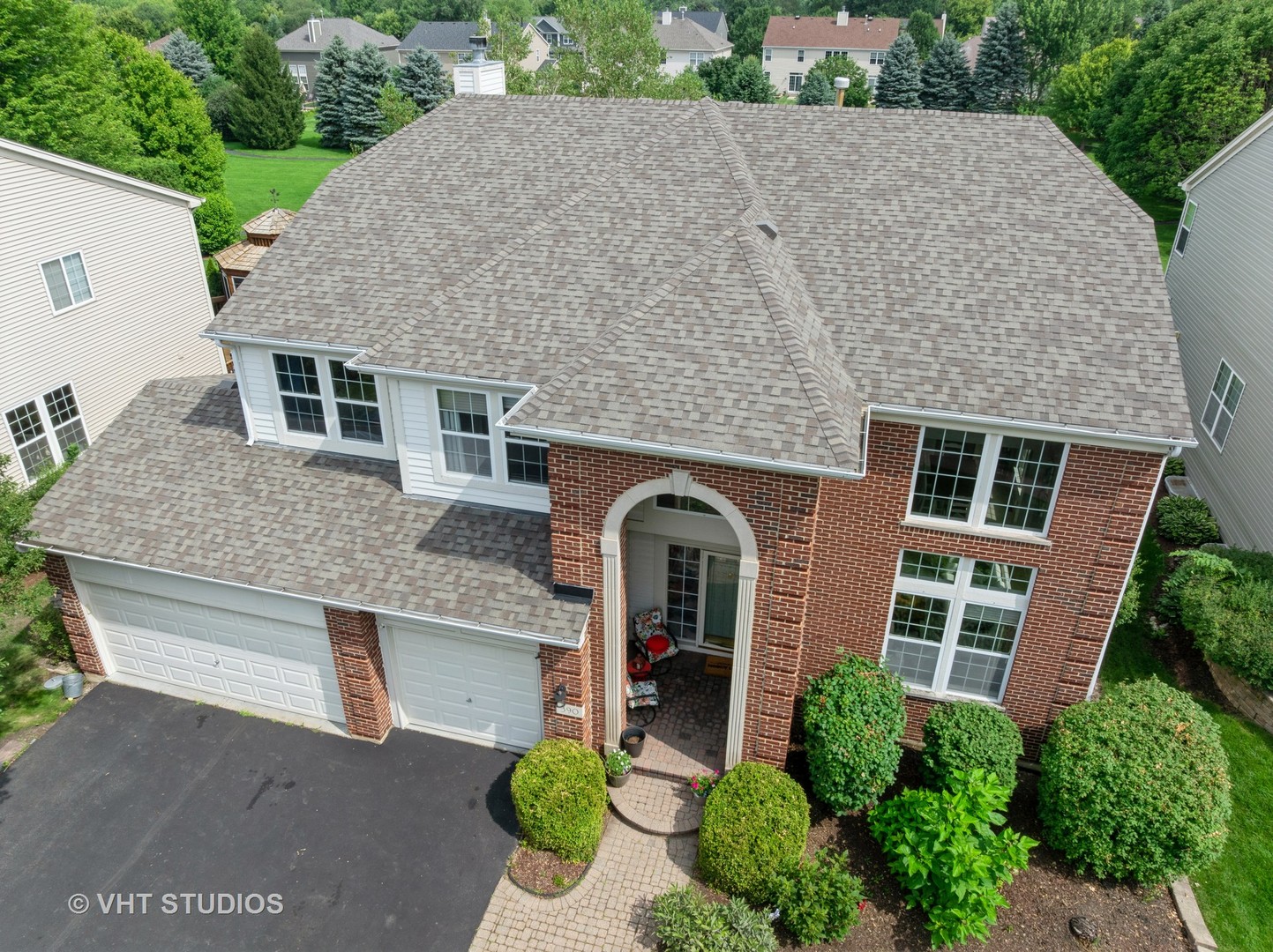 390 Sterling Circle Cary, IL 60013 - Photo 38 of 55 a front view of a house with a garden