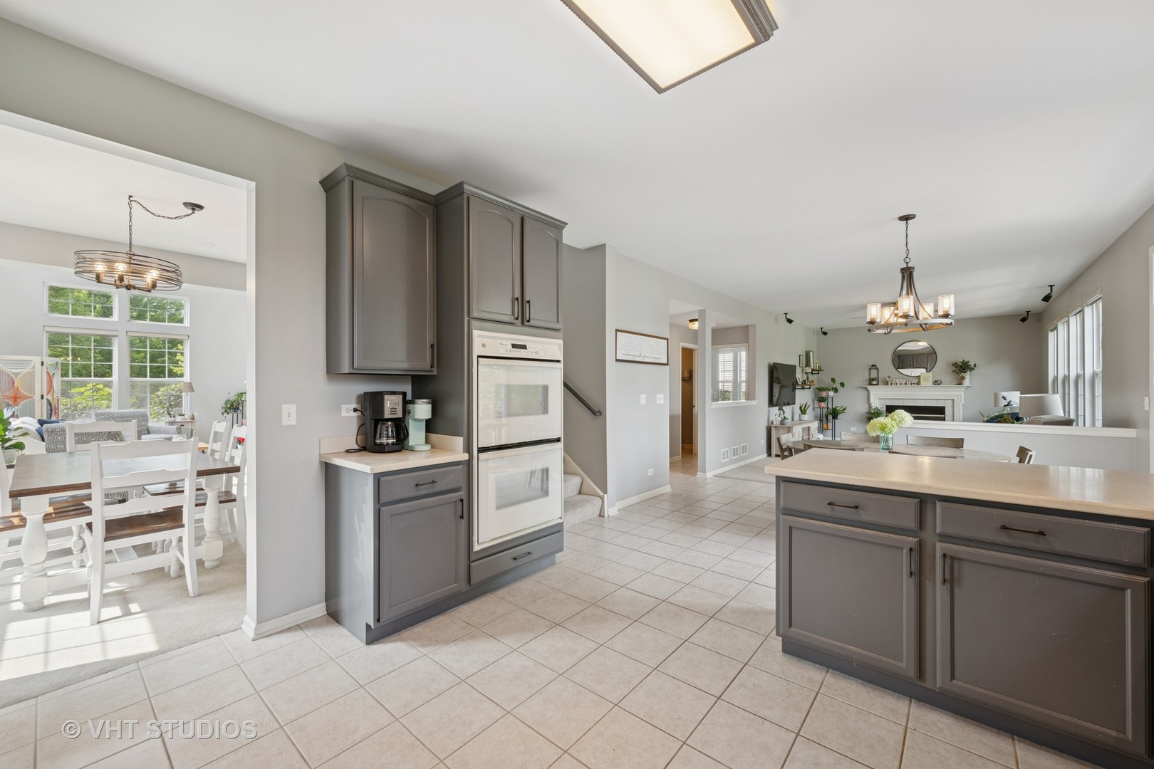390 Sterling Circle Cary, IL 60013 - Photo 6 of 55 a kitchen with cabinets and chairs
