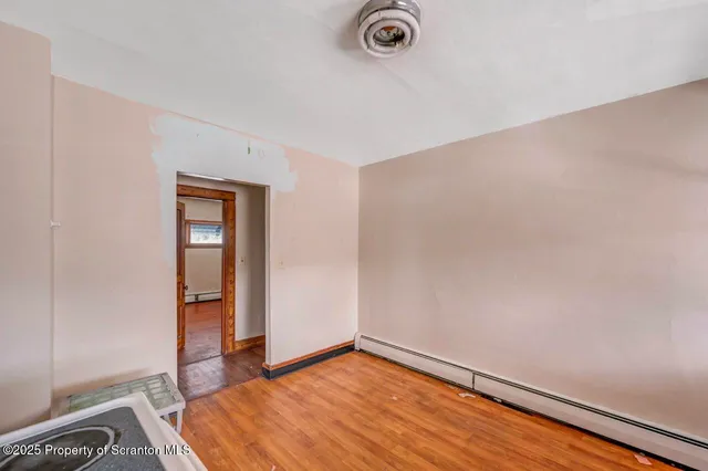 wooden floor in a room next to a window