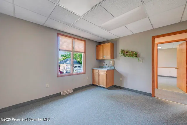 a spacious bathroom with a sink and a mirror