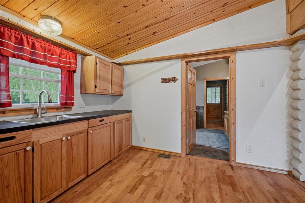 570 Ayres Road Bells, TX 75414 - Photo 19 of 40 a view of a kitchen with wooden floor and a sink