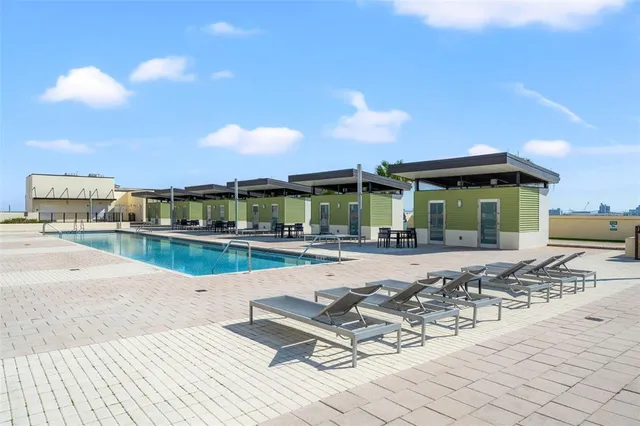 a kitchen with stainless steel appliances a wooden floor a window and cabinets