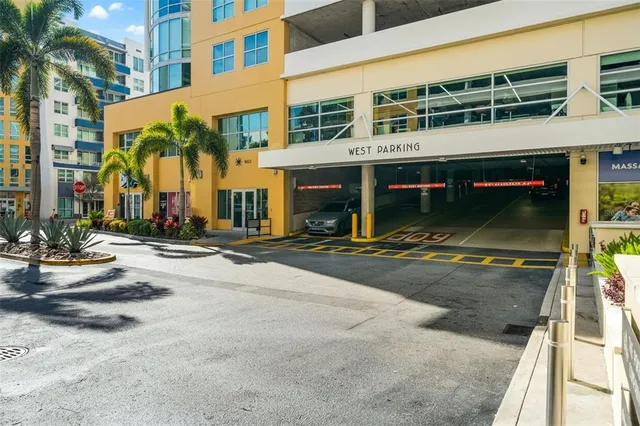 a view of a patio with table and chairs potted plants and palm tree