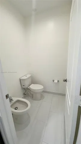 a bathroom with a toilet and a sink