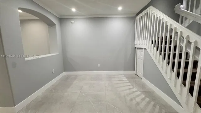 an entryway in a hall with wooden floor